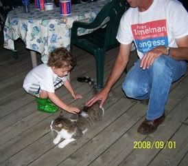 Patrick (2) meets a friendly cat at a supporter's home on Little Rock Lake in Benton County, Sept. 1, 2008.